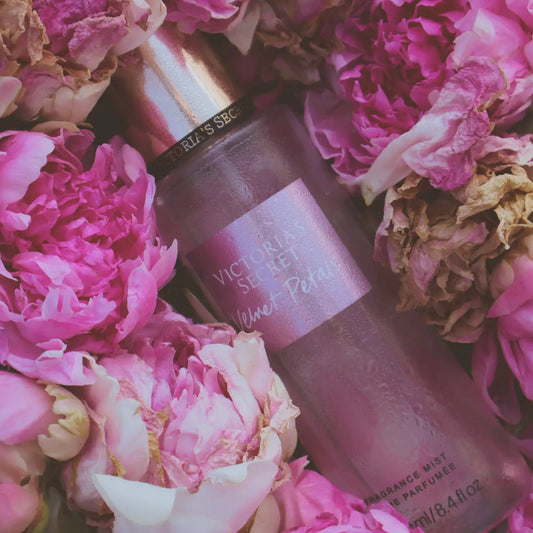 Victoria's Secret perfume bottle surrounded by pink flowers