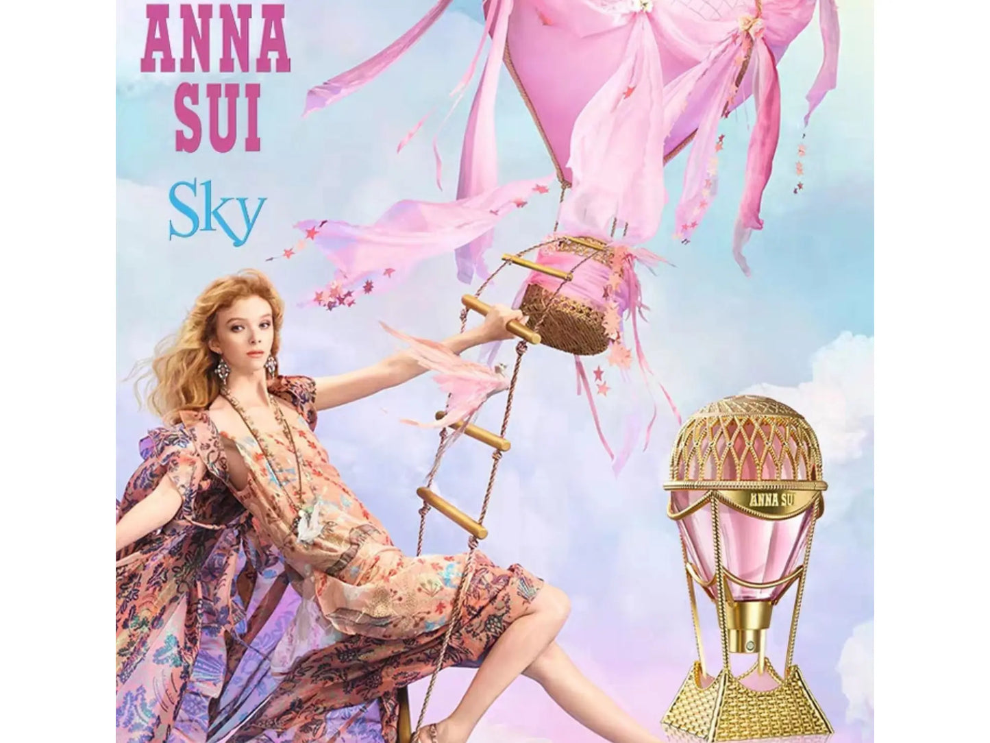 Model in floral dress with 'Anna Sui' product and pink balloons against a blue sky.