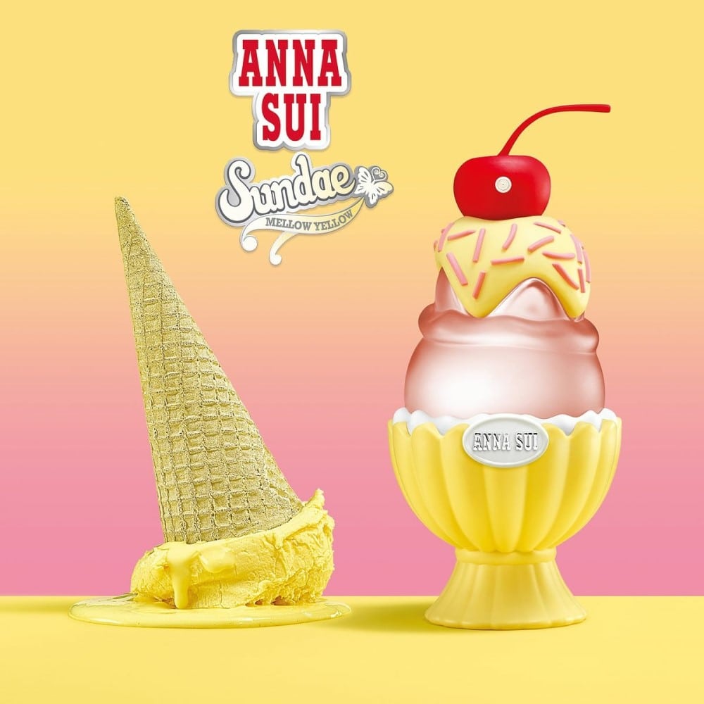 Anna Sui ice cream-themed product with a yellow cone and pink sundae on a gradient background