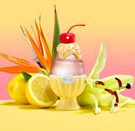 perfume with cherry and sprinkles on a yellow background with lemons and flowers