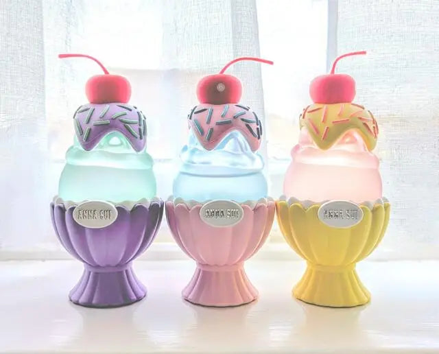 Three colorful ice cream-themed night lights on a white surface with a light background.