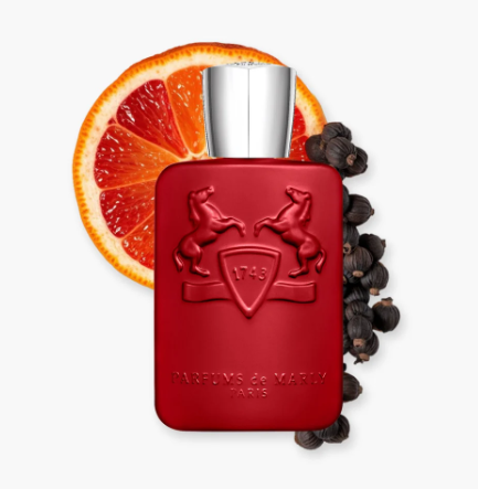 Red perfume bottle with silver cap on a white background, surrounded by orange slices and black peppercorns.