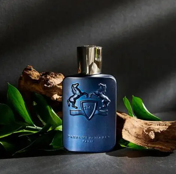 Blue perfume bottle with a logo on a dark background