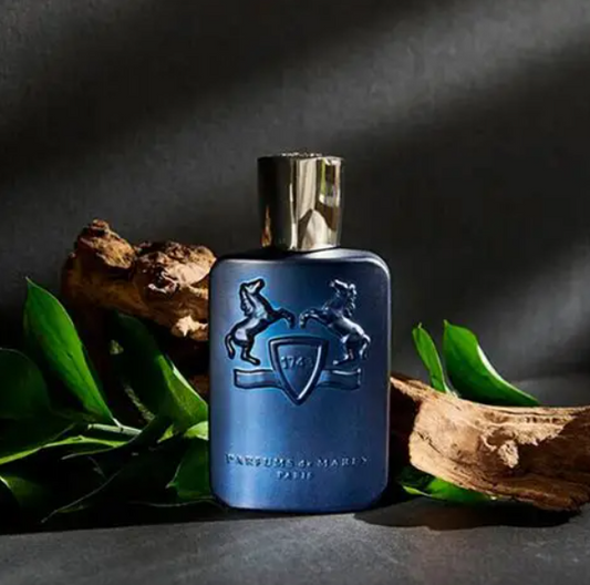 Blue perfume bottle with a logo on a dark background
