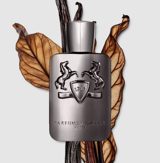 Parfums de Marly perfume bottle with dried leaves on a light background