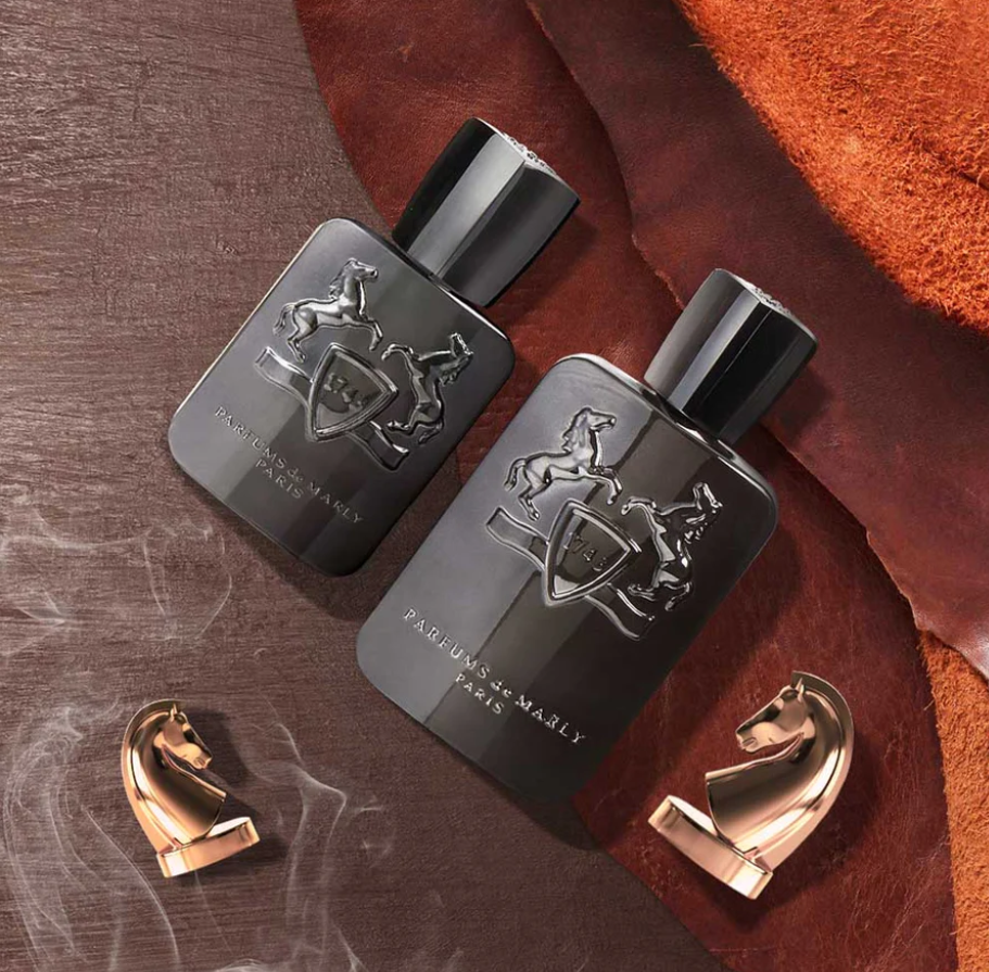 Two dark perfume bottles with a horse emblem on a textured surface