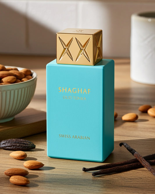 Turquoise perfume bottle with gold cap on a wooden surface with almonds and vanilla beans.
