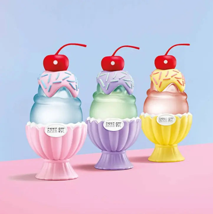 Three ice cream-themed products with colorful bases and red cherries on a pink and blue background.