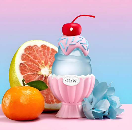 Colorful ice cream-themed bottle with cherry on top, surrounded by fruits and flowers on a pastel background