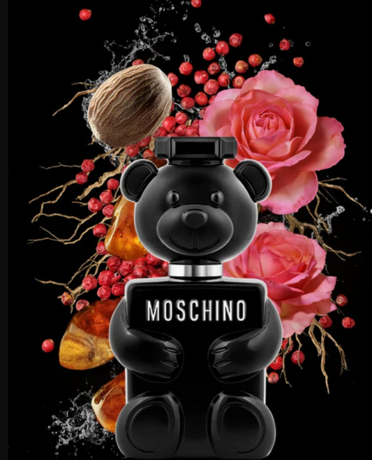 Black bear-shaped Moschino perfume bottle with flowers and berries on a black background