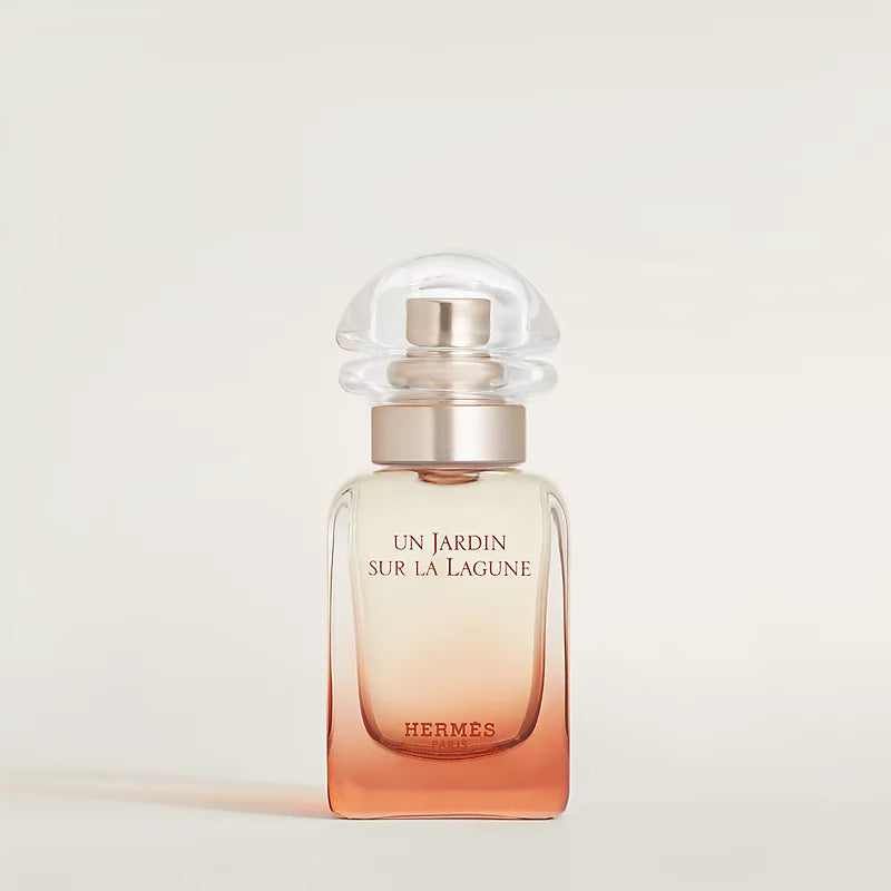 Hermes perfume bottle with gradient design on a light background