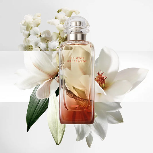 Perfume bottle with flowers on a light background