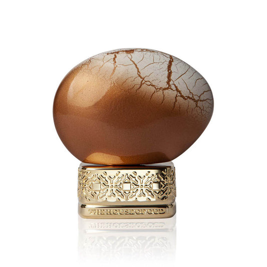 Decorative object with a cracked brown surface and gold base on a white background