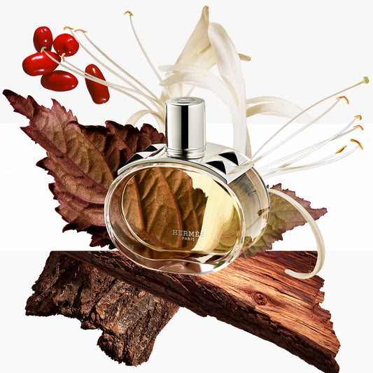 Hermes perfume bottle with autumn leaves and berries on a white background