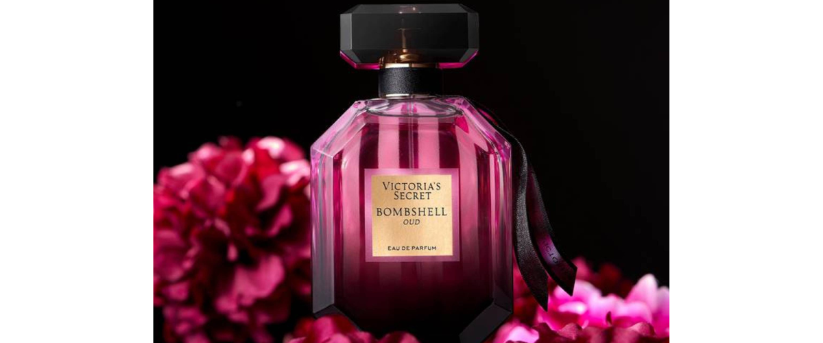 Victoria's Secret perfume bottle with pink flowers in the background