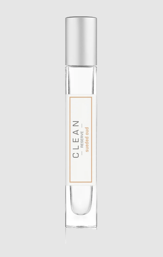 Clear perfume bottle with silver cap on a light gray background