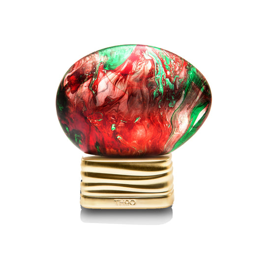 Marbled red and green object on a gold stand with branding