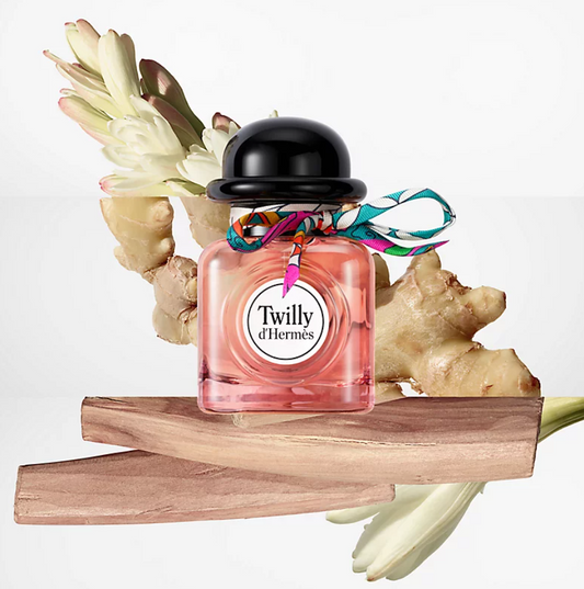 Perfume bottle labeled 'Twilly d'Hermes' with decorative elements on a white background